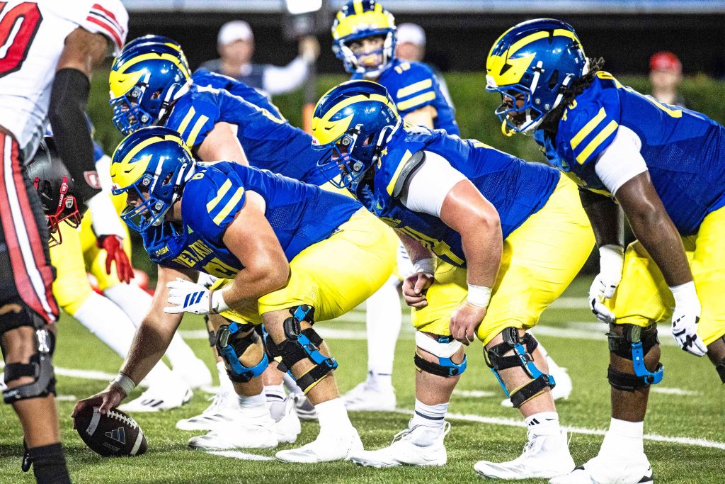 The Delaware Blue Hens are ready for the snap against Western Kentucky during Delaware's first home CUSA football game, which was nationally televised, at Delaware Stadium in Newark on Oct. 3, 2025. Western Kentucky won 27-24.