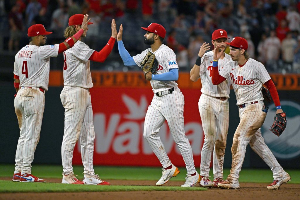 Aug 17, 2026; Philadelphia, Pennsylvania, USA; Philadelphia Phillies center fielder Derek Hill (49) high fives teammates after win against the Miami Marlins at Citizens Bank Park.