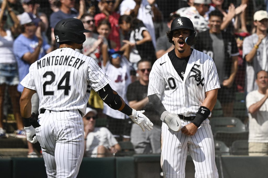 Aug 23, 2026; Chicago, Illinois, USA; Chicago White Sox third baseman Miguel Vargas (20) celebrates with right fielder Braden Montgomery (24) after he scores against the New York Mets during the eighth inning at Rate Field.