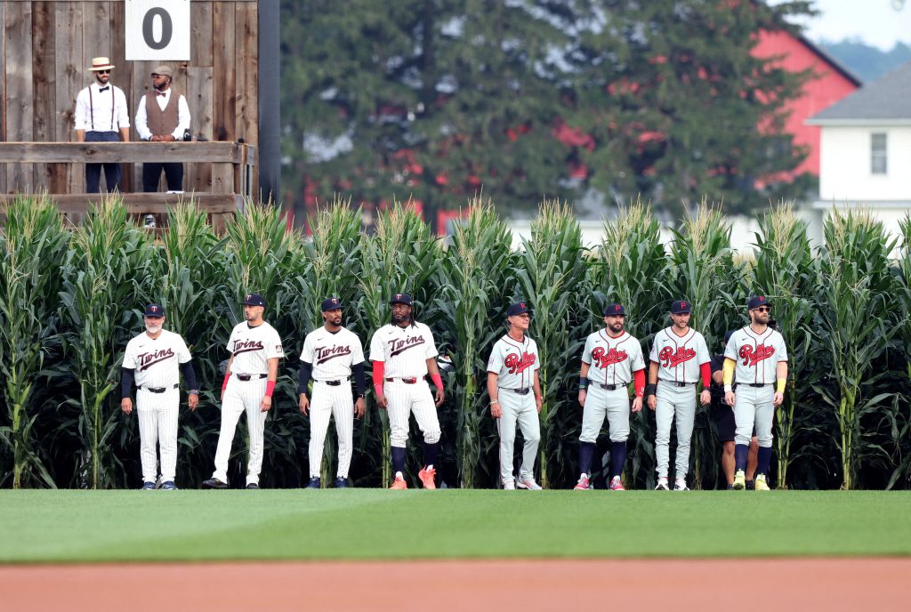 Aug 13, 2026; Dyersville, Iowa, USA; Members of the Minnesota Twins and Philadelphia Phillies walk out of the corn at the Field of Dreams.