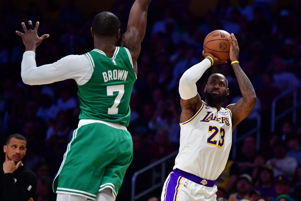 Feb 22, 2026; Los Angeles, California, USA; Los Angeles Lakers forward LeBron James (23) shoots against Boston Celtics guard Jaylen Brown (7) during the second half at Crypto.com Arena.