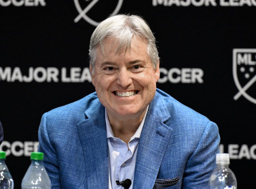 Aug 4, 2026; New York, NY, USA; Larry Berg smiles at an introductory press conference after being named the next commissioner at MLS Headquarters.