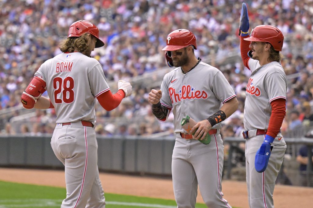 Aug 16, 2026; Minneapolis, Minnesota, USA; Philadelphia Phillies infielder Alec Bohm (28) celebrates his three-run home run against the Minnesota Twins with infielder Bryce Harper (3) and infielder Bryson Stott (5) during the sixth inning at Target Field.