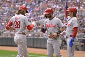 Aug 16, 2026; Minneapolis, Minnesota, USA; Philadelphia Phillies infielder Alec Bohm (28) celebrates his three-run home run against the Minnesota Twins with infielder Bryce Harper (3) and infielder Bryson Stott (5) during the sixth inning at Target Field.