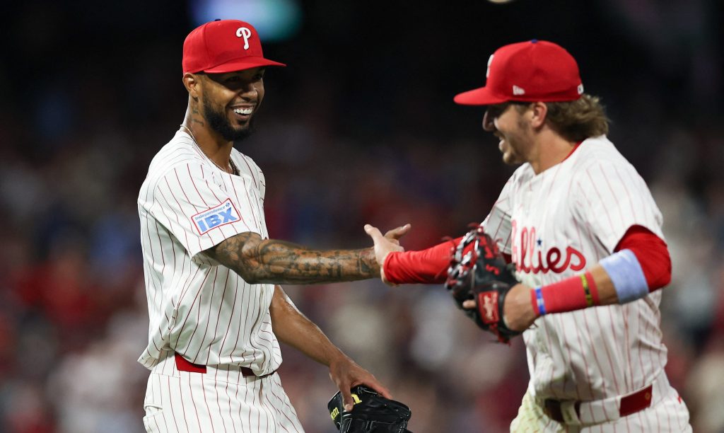 Aug 3, 2025; Philadelphia, Pennsylvania, USA; Philadelphia Phillies pitcher Cristopher Sanchez (L) slaps hands with second base Bryson Stott (R) after his play to end the eighth inning against the Detroit Tigers at Citizens Bank Park.