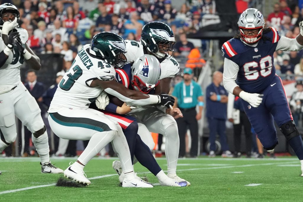 Aug 22, 2026; Foxborough, Massachusetts, USA; Philadelphia Eagles linebacker Jose Ramirez (43) and linebacker Joshua Weru (46) sack New England Patriots quarterback Behren Morton (15) during the second half at Gillette Stadium.