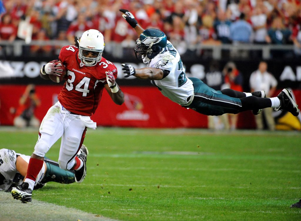 Jan 18, 2009; Glendale, AZ, USA; Arizona Cardinals running back Tim Hightower (34) tries to elude a diving tackle attempt by Philadelphia Eagles free safety Brian Dawkins (20) in the the fourth quarter of the NFC Championship at University of Phoenix Stadium. The Cardinals defeated the Eagles 32-25.