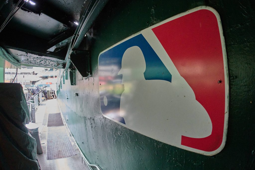 Aug 24, 2024; Oakland, California, USA; The major league baseball logo is seen on signage near the player's entrance to the field at Oakland-Alameda County Coliseum before the game between the Oakland Athletics and the Milwaukee Brewers.