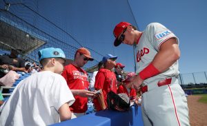 Mar 2, 2025; Dunedin, Florida, USA; Philadelphia Phillies infielder Aidan Miller (81) signs autographs for fans before a game against the Toronto Blue Jays during spring training at TD Ballpark.