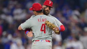 Sep 15, 2025; Los Angeles, California, USA; Philadelphia Phillies third baseman Otto Kemp (4) and first baseman Bryce Harper (3) celebrate the victory against the Los Angeles Dodgers and clinching the National League East division title at Dodger Stadium.