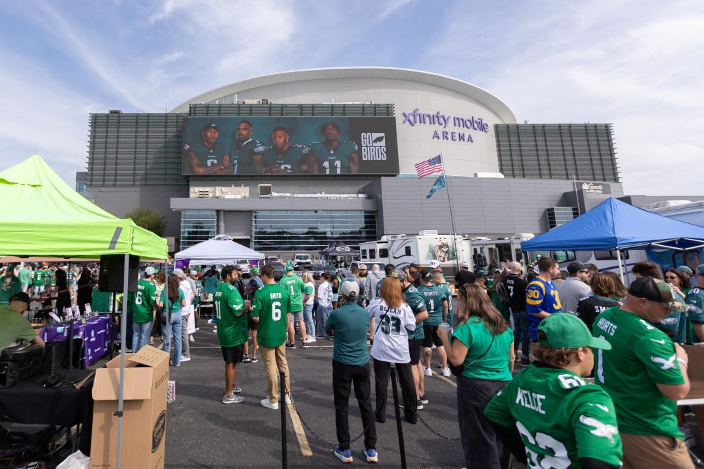 Fans of the Philadelphia Eagles and Los Angeles Rams tailgate together before a Week 3 NFL game at Lincoln Financial Field in Philadelphia on Sept. 21, 2025.