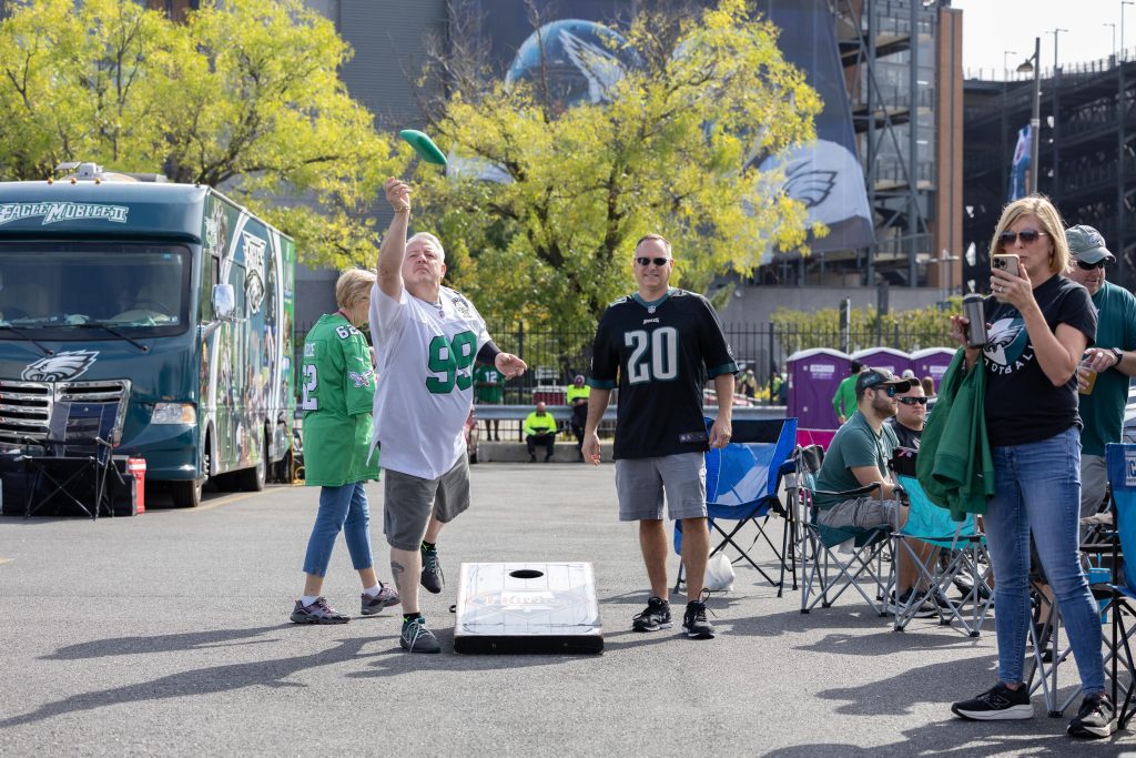 Fans of the Philadelphia Eagles and Los Angeles Rams tailgate together before a Week 3 NFL game at Lincoln Financial Field in Philadelphia on Sept. 21, 2025.