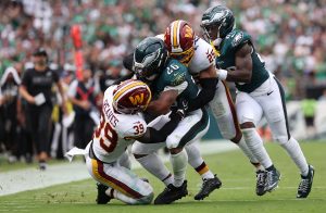 Sep 13, 2026; Philadelphia, Pennsylvania, USA; Philadelphia Eagles running back Saquon Barkley (26) runs the ball against Washington Commanders safety Jeremy Reaves (39) during the first half at Lincoln Financial Field.