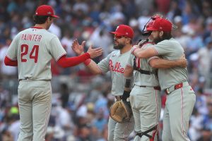 Sep 30, 2026; Cumberland, Georgia, USA; Philadelphia Phillies pitcher Andrew Painter (24), designated hitter Kyle Schwarber (12), catcher J.T. Realmuto (10) and outfielder Brandon Marsh (16) celebrate after a win against the Atlanta Braves in game two of the Wildcard round for the 2026 MLB Playoffs at Truist Park.