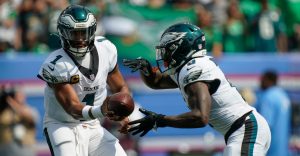 Philadelphia Eagles quarterback Jalen Hurts (1) hands off to running back Tank Bigsby (8) for a touchdown during the second quarter against the Tennessee Titans at Nissan Stadium in Nashville, Tenn., Sunday, Sept. 20, 2026.