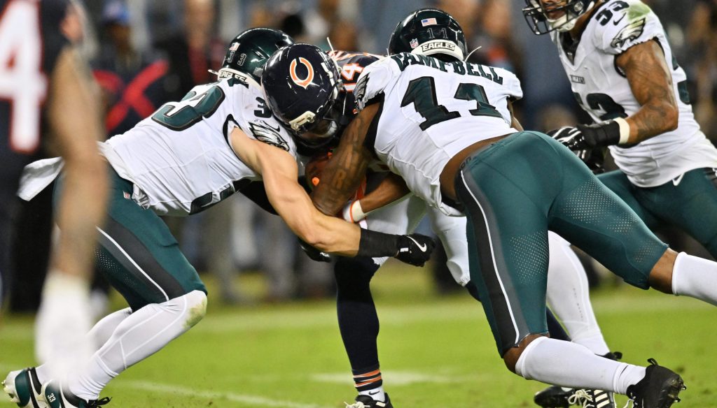 Sep 28, 2026; Chicago, Illinois, USA; Philadelphia Eagles defensive back Cooper DeJean (33) and linebacker Jihaad Campbell (11) tackle Chicago Bears wide receiver Kalif Raymond (14) during the first half at Soldier Field.