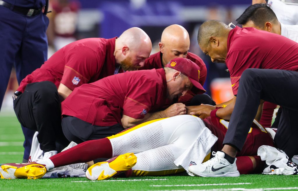 Sep 20, 2026; Arlington, Texas, USA; Washington Commanders quarterback Jayden Daniels (5) lays injured during the game against the Dallas Cowboys at AT&T Stadium.