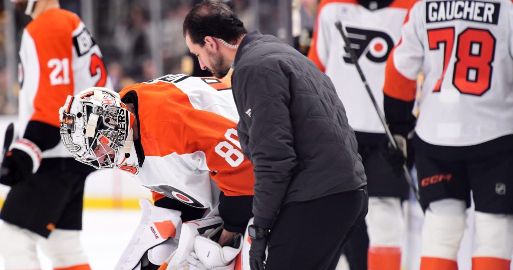 Sep 22, 2026; Boston, Massachusetts, USA; Philadelphia Flyers goaltender Dan Vladar (80) is checked by a member of the training staff during the first period against the Boston Bruins at TD Garden.