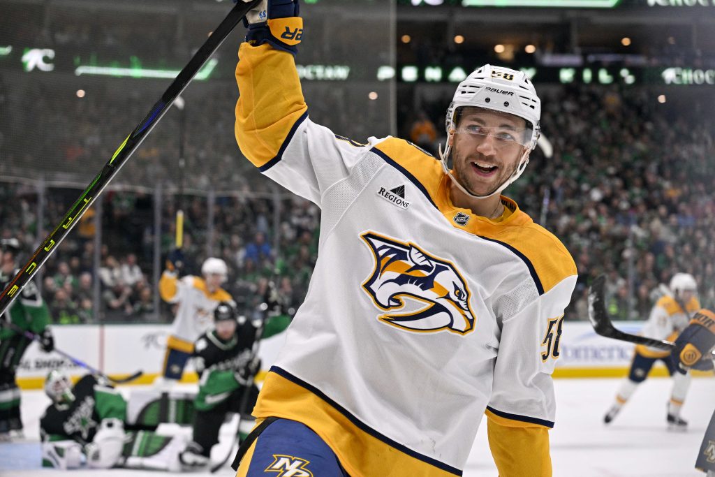 Feb 28, 2026; Dallas, Texas, USA; Nashville Predators left wing Michael Bunting (58) celebrates scoring a power play goal against Dallas Stars goaltender Jake Oettinger (29) during the first period at the American Airlines Center.