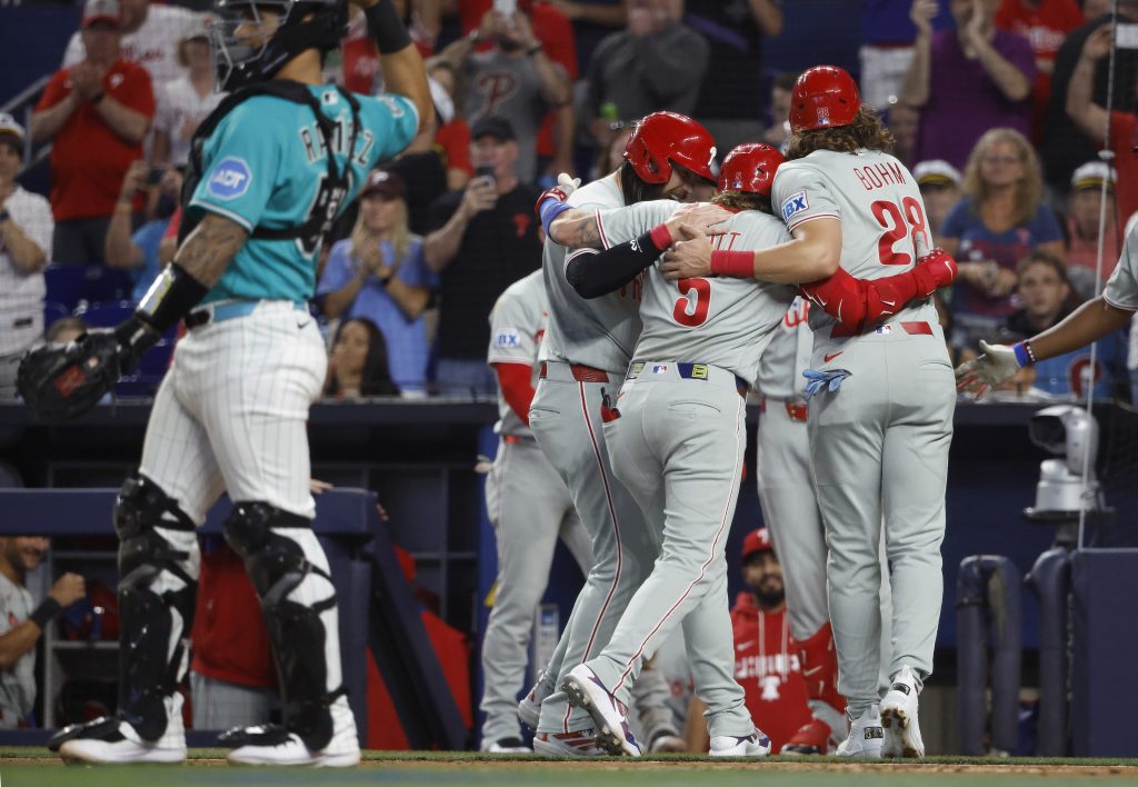 May 3, 2026; Miami, Florida, USA; Philadelphia Phillies third baseman Alec Bohm (28) and center fielder Brandon Marsh (16) and second baseman Bryson Stott (5) celebrate at the plate after Stott's home run against the Miami Marlins during the first inning at loanDepot Park.