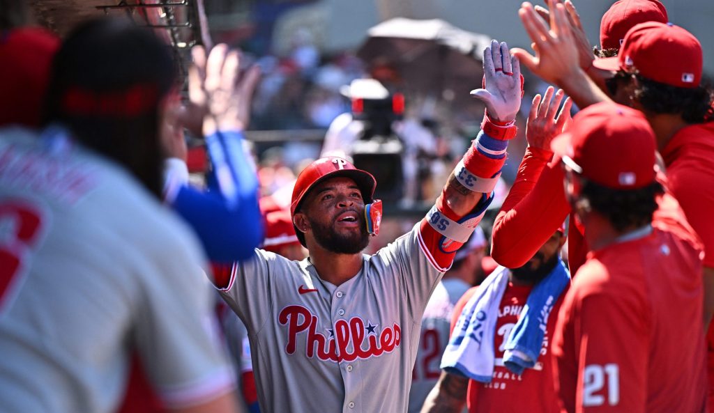 Aug 30, 2026; Anaheim, California, USA; Philadelphia Phillies third baseman Edmundo Sosa (33) is greeted by teammates after hitting a solo home run during the seventh inning against the Los Angeles Angels at Angel Stadium.