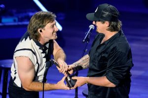 Presenter Morgan Wallen, left, hands the award to HARDY after announcing him the winner of the Songwriter of the Year award during the 15th annual Academy Of Country Music Honors event at the Ryman Auditorium in Nashville on Aug. 24, 2022.