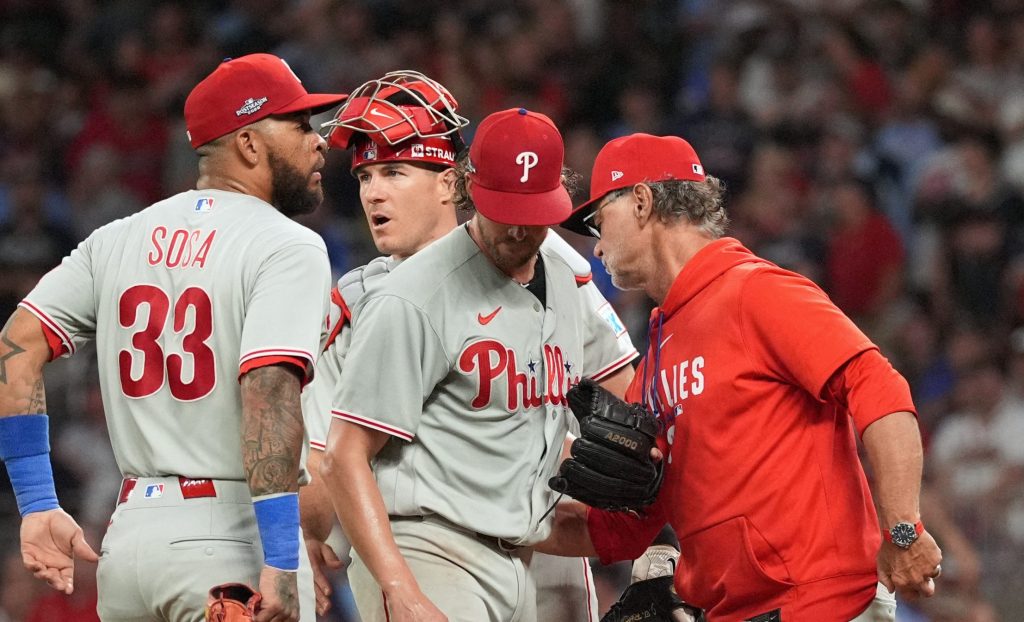 Oct 1, 2026; Cumberland, Georgia, USA; Philadelphia Phillies starting pitcher Aaron Nola (27) walks to the dugout after pitching change made by interim manager Don Mattingly (8) against the Atlanta Braves during the second inning in game three of the Wildcard round for the 2026 MLB Playoffs at Truist Field.