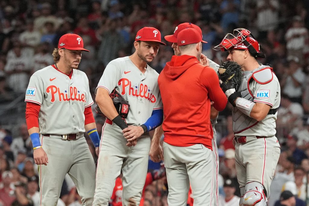 Oct 1, 2026; Cumberland, Georgia, USA; Philadelphia Phillies infielder Trea Turner (7) listens to pitching coach Caleb Cotham (65) with infielders Bryson Stott (5) and Edmundo Sosa (33) during a mound visit against the Atlanta Braves in the sixth inning in game three of the Wildcard round for the 2026 MLB Playoffs at Truist Field.