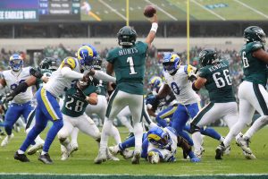 Oct 4, 2026; Philadelphia, Pennsylvania, USA; Philadelphia Eagles quarterback Jalen Hurts (1) throws a pass against Los Angeles Rams safety Kam Curl (3) and linebacker Byron Young (0) during the second half at Lincoln Financial Field.