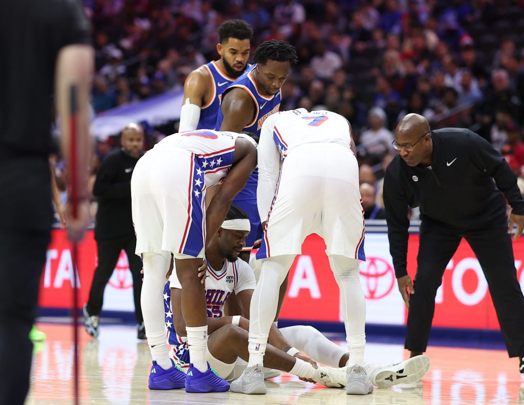 Oct 5, 2026; Philadelphia, Pennsylvania, USA; Philadelphia 76ers center Ariel Hukporti (55) sits on the court after an injury during the first quarter against the New York Knicks at Xfinity Mobile Arena.