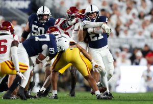 Oct 10, 2026; University Park, Pennsylvania, USA; Penn State Nittany Lions running back Carson Hansen (21) runs with the ball before being tackle by Southern California Trojans linebacker Desman Stephens II (8) during the first quarter of the game at West Shore Home Field at Beaver Stadium.