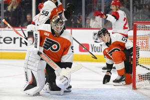 Oct 11, 2026; Philadelphia, Pennsylvania, USA; Philadelphia Flyers goaltender Joseph Woll (53) and defenseman Oliver Bonk (59) react after a Carolina Hurricanes goal during the second period at Xfinity Mobile Arena.