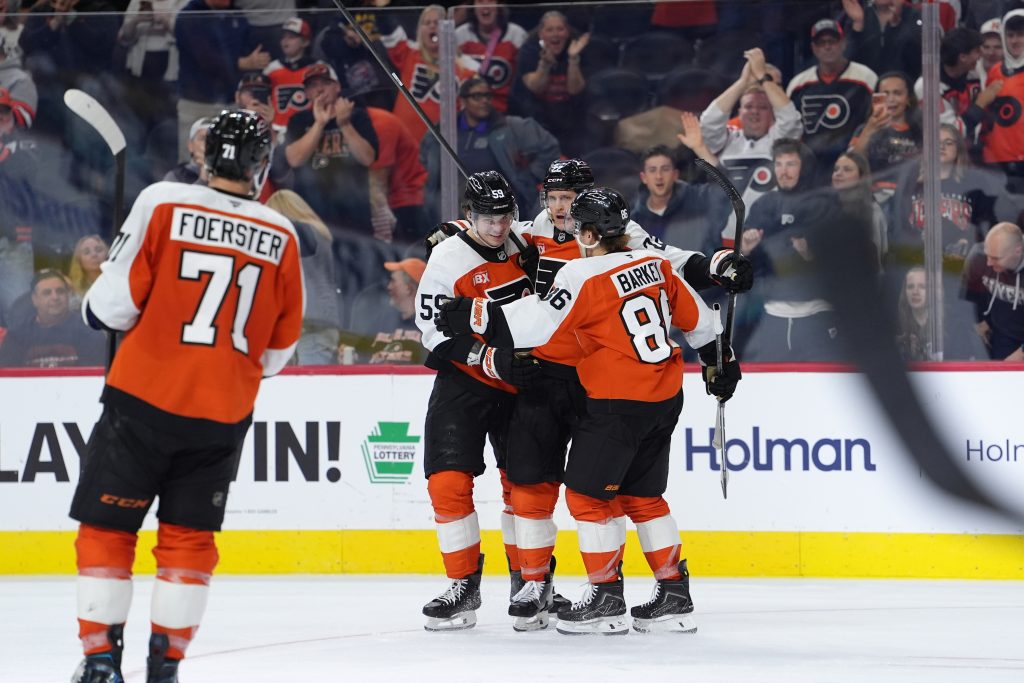 Oct 13, 2026; Philadelphia, Pennsylvania, USA; Philadelphia Flyers center Christian Dvorak (22) celebrates with teammates after scoring a goal against the Seattle Kraken in the third period at Xfinity Mobile Arena.