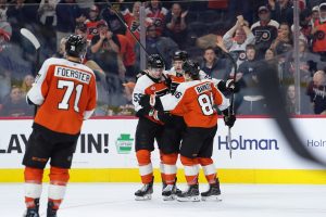 Oct 13, 2026; Philadelphia, Pennsylvania, USA; Philadelphia Flyers center Christian Dvorak (22) celebrates with teammates after scoring a goal against the Seattle Kraken in the third period at Xfinity Mobile Arena.
