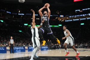 Oct 16, 2026; San Antonio, Texas, USA; Sacramento Kings guard Ben Simmons (25) drives to the basket between forward Keldon Johnson (3) and center Tarris Reed, Jr. (10) during the second half against the San Antonio Spurs at Frost Bank Center.