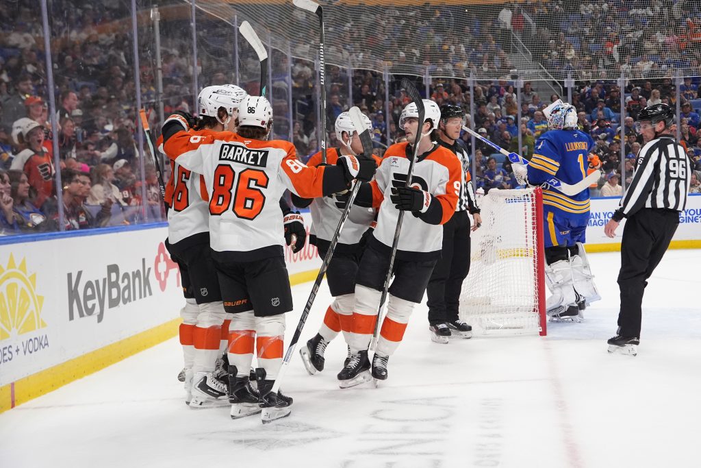 Oct 21, 2026; Buffalo, New York, USA; Philadelphia Flyers center Trevor Zegras (46) is congratulated by teammates for scoring a goal against the Buffalo Sabres during the first period at KeyBank Center. Mandatory Credit: