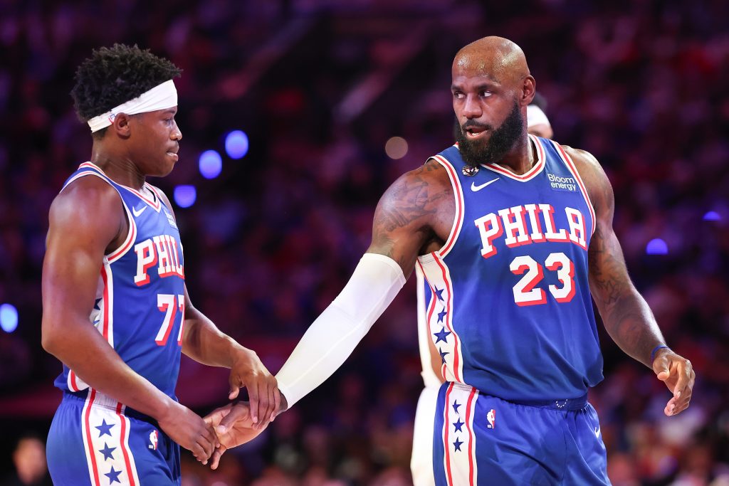 Oct 22, 2026; Philadelphia, Pennsylvania, USA; Philadelphia 76ers forward LeBron James (23) reacts with guard Vj Edgecombe (77) after a play against the Cleveland Cavaliers during the first quarter at Xfinity Mobile Arena. Mandatory Credit: