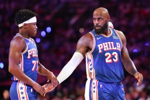 Oct 22, 2026; Philadelphia, Pennsylvania, USA; Philadelphia 76ers forward LeBron James (23) reacts with guard Vj Edgecombe (77) after a play against the Cleveland Cavaliers during the first quarter at Xfinity Mobile Arena. Mandatory Credit: