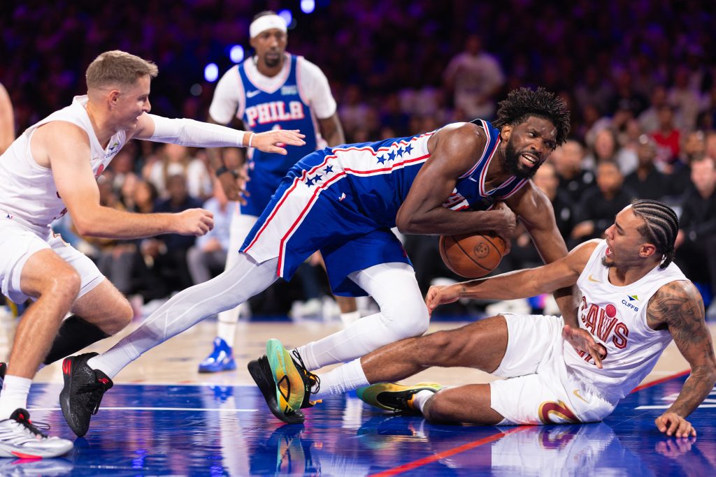 Oct 22, 2026; Philadelphia, Pennsylvania, USA; Philadelphia 76ers center Joel Embiid (21) dives to take the ball away from Cleveland Cavaliers guard Jaylon Tyson (20) during the third quarter at Xfinity Mobile Arena. Mandatory Credit: