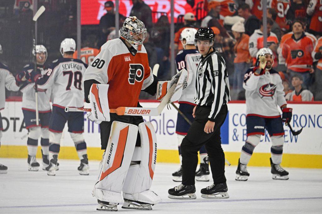 Oct 27, 2026; Philadelphia, Pennsylvania, USA; Philadelphia Flyers goaltender Dan Vladar (80) skates off the ice as Columbus Blue Jackets celebrate win during the overtime period at Xfinity Mobile Arena.