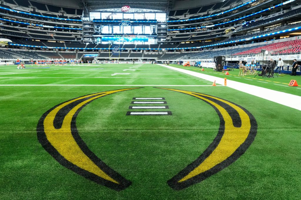 The College Football Playoff logo is painted in the endzone prior to the Cotton Bowl between the Ohio State Buckeyes and the Miami Hurricanes at AT&T Stadium in Arlington, Texas on Dec. 31, 2025.