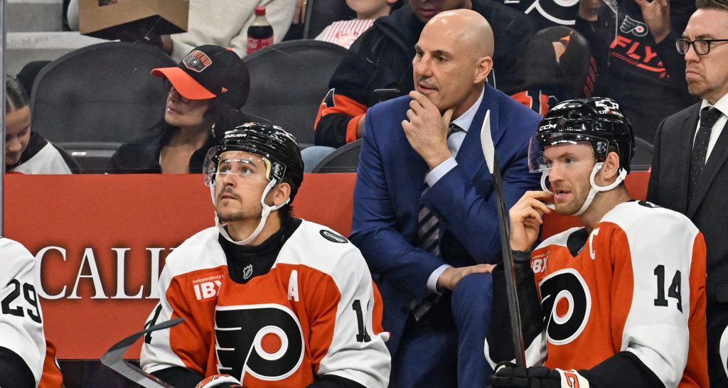 Oct 13, 2025; Philadelphia, Pennsylvania, USA; Philadelphia Flyers head coach Rick Tocchet with right wing Travis Konecny (11) and center Sean Couturier (14) against the Florida Panthers during the first period at Wells Fargo Center.