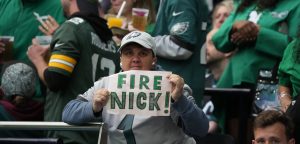 Oct 11, 2026; Tottenham, ENG; Oct 11, 2026; Tottenham, ENG; A fan holds a sign imploring the Philadelphia Eagles to fire head coach Nick Sirianni during the second half of the game against the Jacksonville Jaguars at Tottenham Hotspur Stadium. Mandatory Credit: Kirby Lee-Imagn Images.