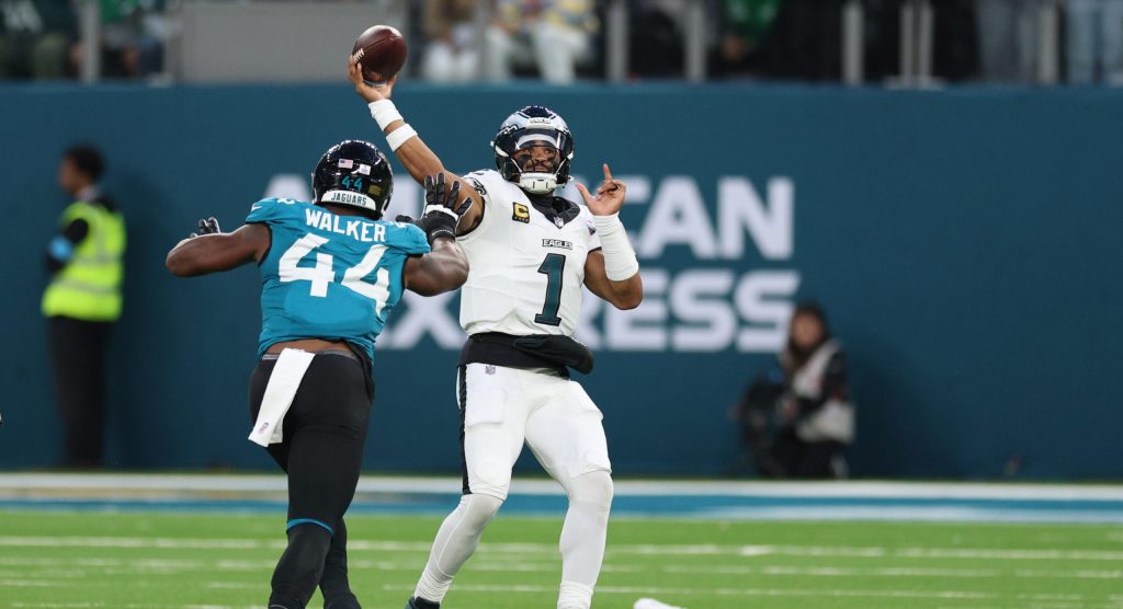 Oct 11, 2026; Tottenham, ENG; Philadelphia Eagles quarterback Jalen Hurts (1) throws a pass as Jacksonville Jaguars defensive end Travon Walker (44) defends during the fourth quarter at Tottenham Hotspur Stadium.