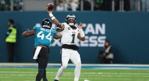 Oct 11, 2026; Tottenham, ENG; Philadelphia Eagles quarterback Jalen Hurts (1) throws a pass as Jacksonville Jaguars defensive end Travon Walker (44) defends during the fourth quarter at Tottenham Hotspur Stadium.