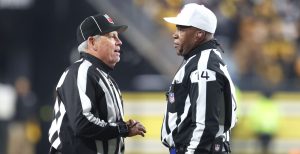 Jan 4, 2026; Pittsburgh, Pennsylvania, USA; NFL line judge Jeff Seeman (left) and referee Shawn Smith (14) discuss a call during the fourth quarter between the Baltimore Ravens and the Pittsburgh Steelers at Acrisure Stadium.