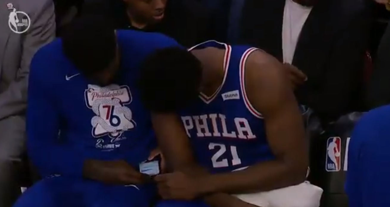 Amir Johnson and Joel Embiid looking at Amir's cell phone