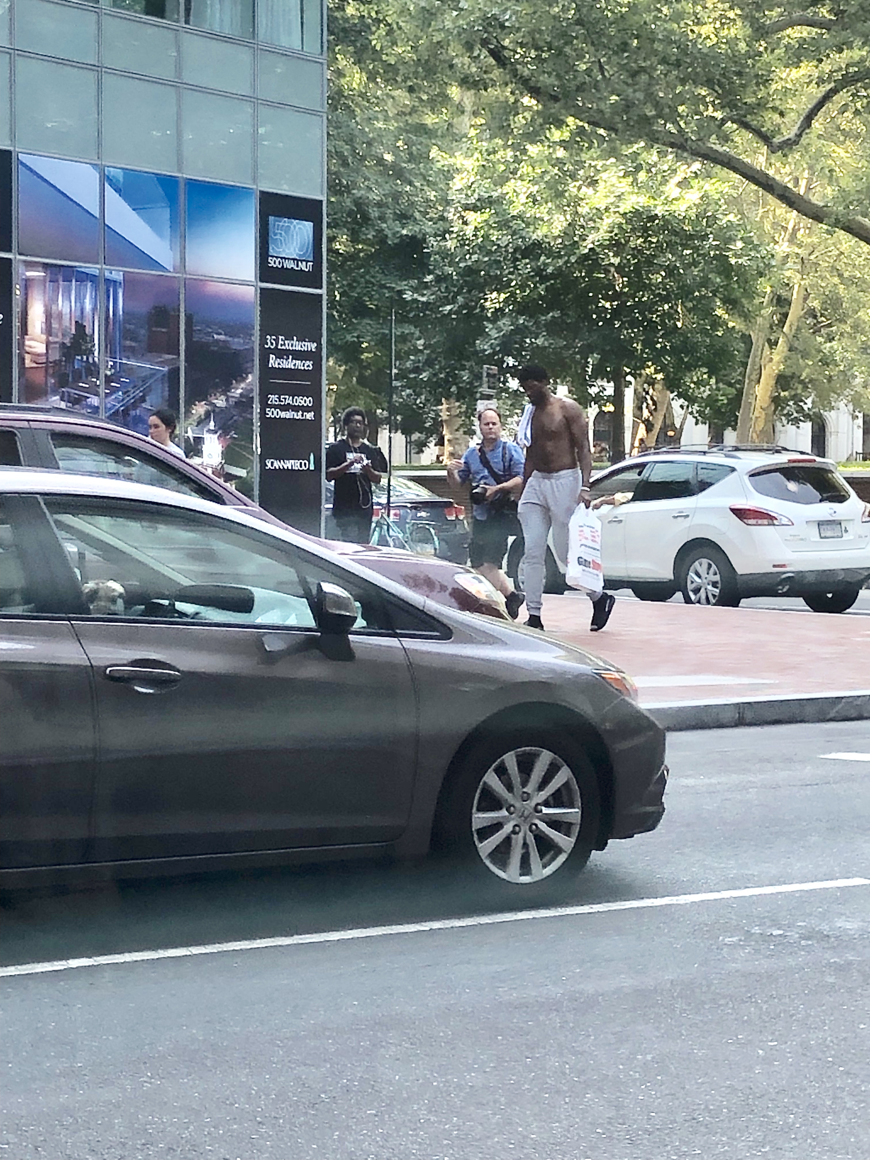 Joel Embiid Takes a Shirtless Saunter Through the Streets of Philly